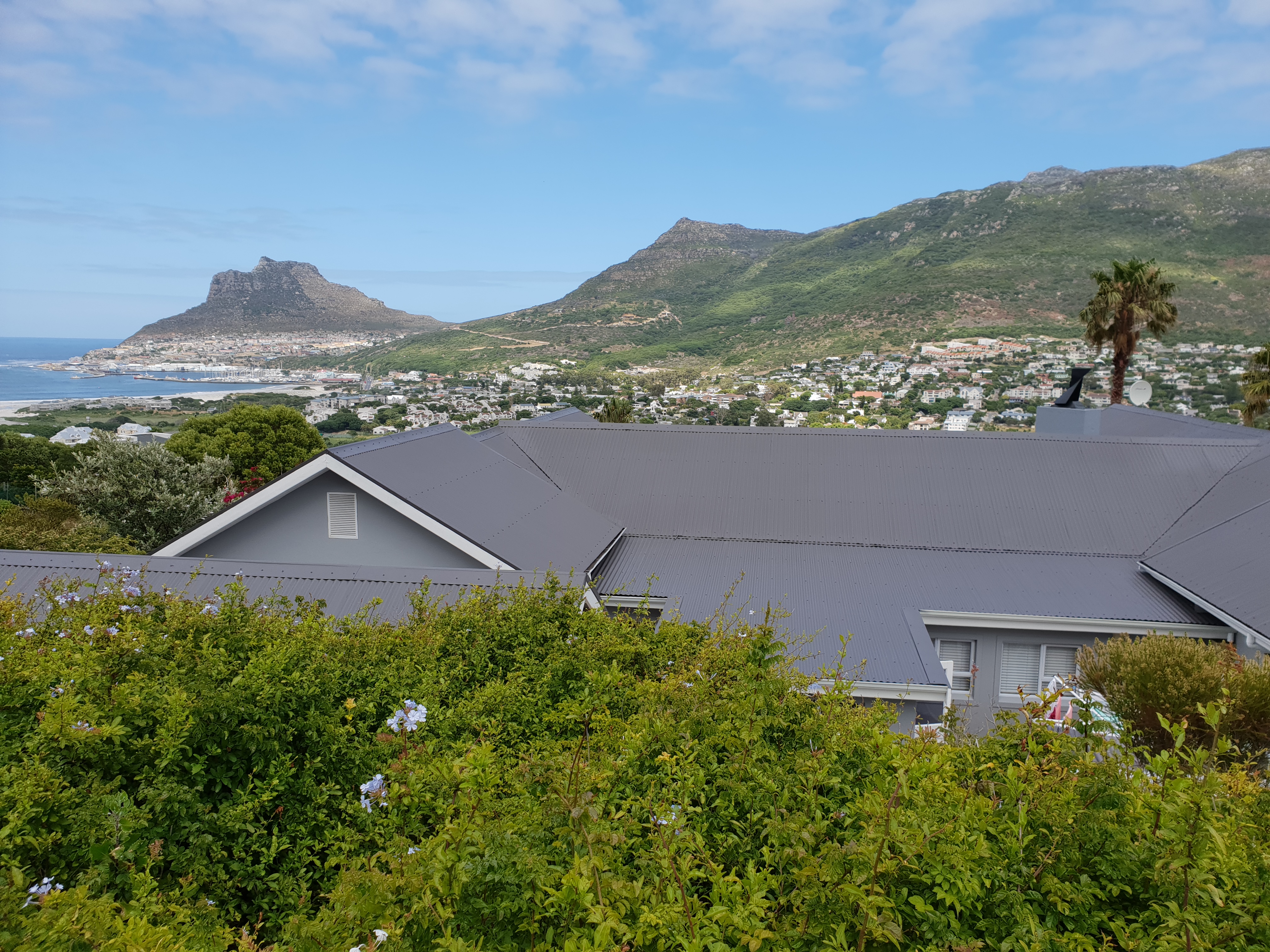 Completed grey roof with Cape Town mountains in the distance