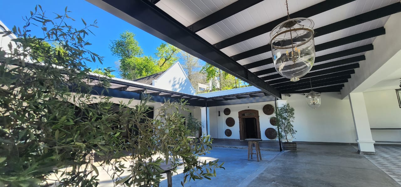 Covered patio with black beams and translucent roofing