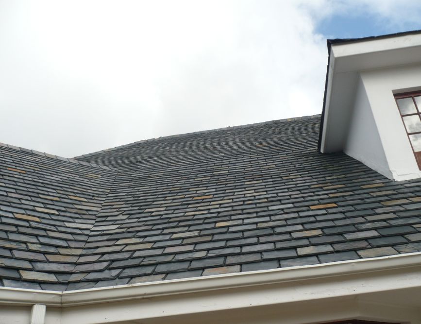 Natural slate roof on a white house
