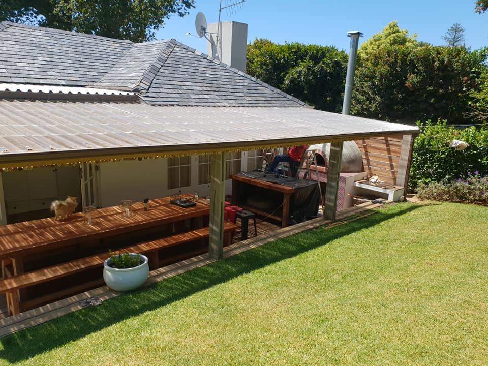 Polycarbonate patio roof over an outdoor area